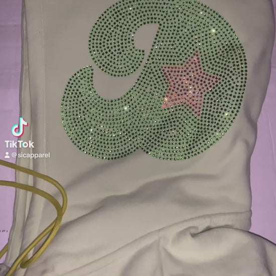 Video of custom rhinestone design on the side of hoodie