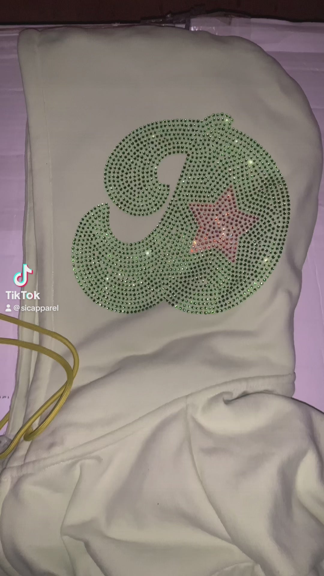 Video of custom rhinestone design on the side of hoodie