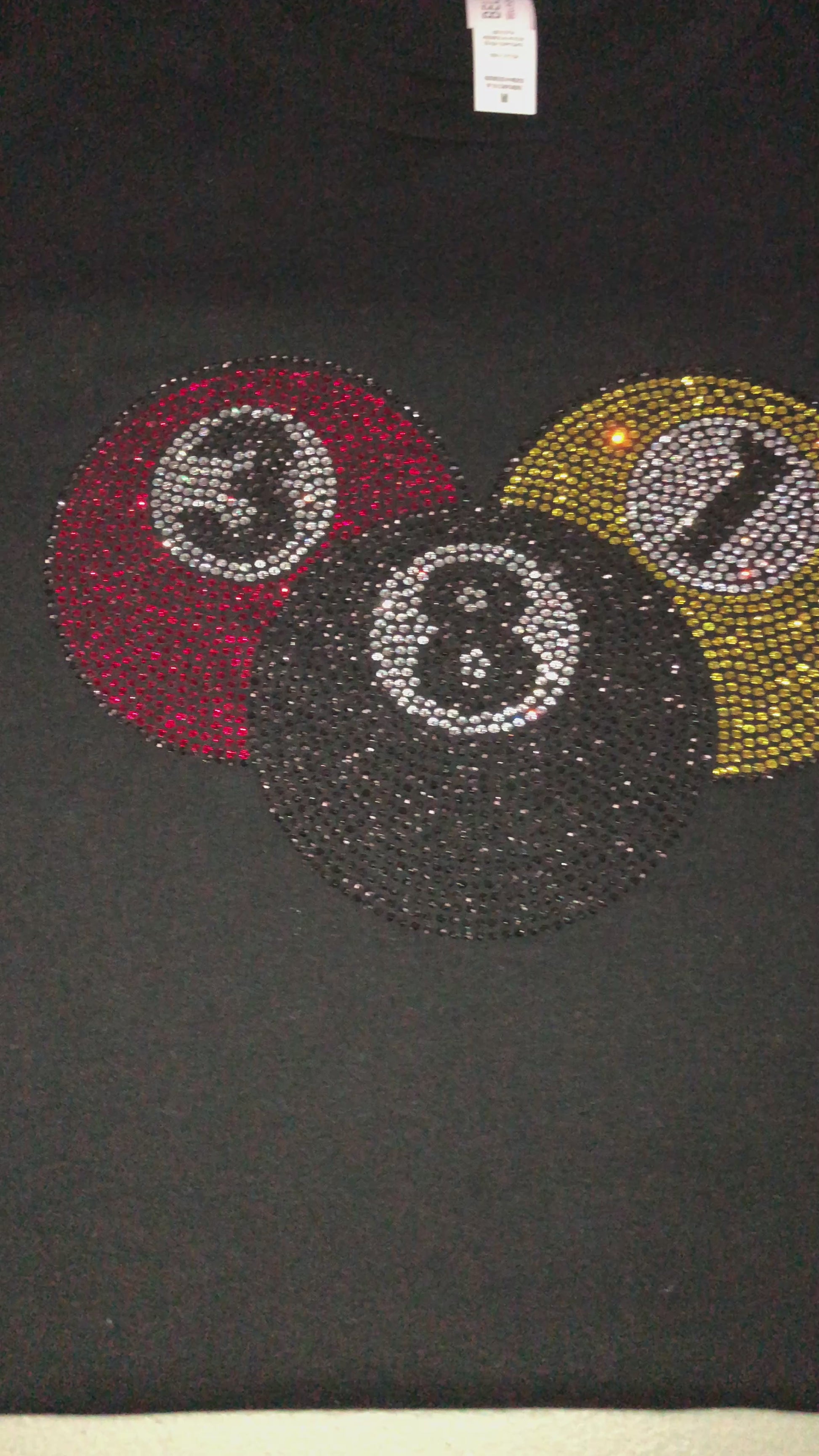 Video of custom rhinestone design on womens black t shirt