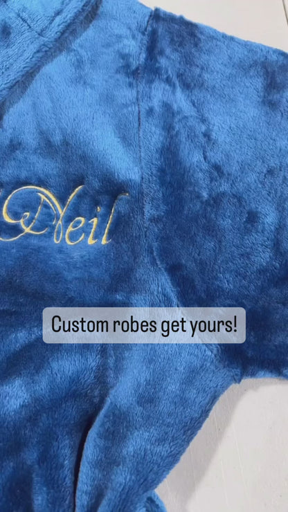 Video of Plush fleece navy blue bathrobe with hood and custom embroidery name.